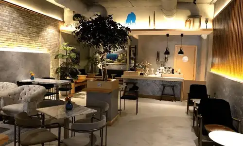 Warm, inviting interior of Café Capri with customers and staff