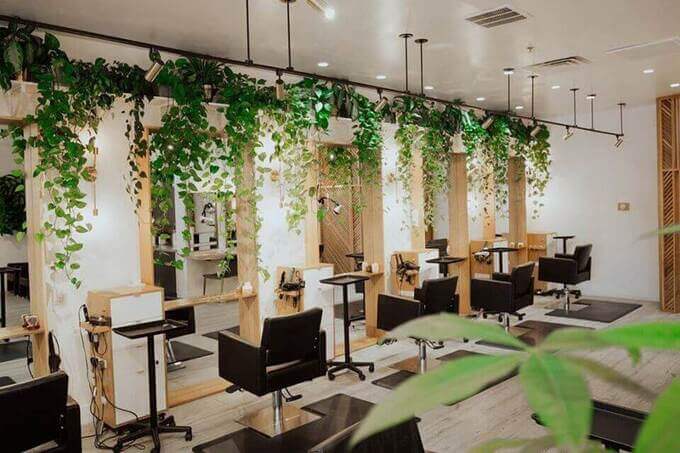 Bright, modern salon interior with stylist and client